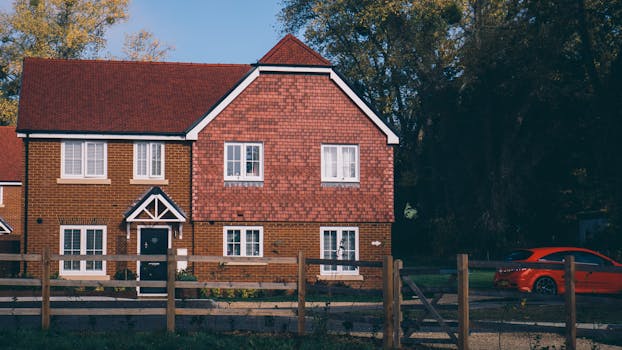 Quaint English family home with red brick and car in Farnham.